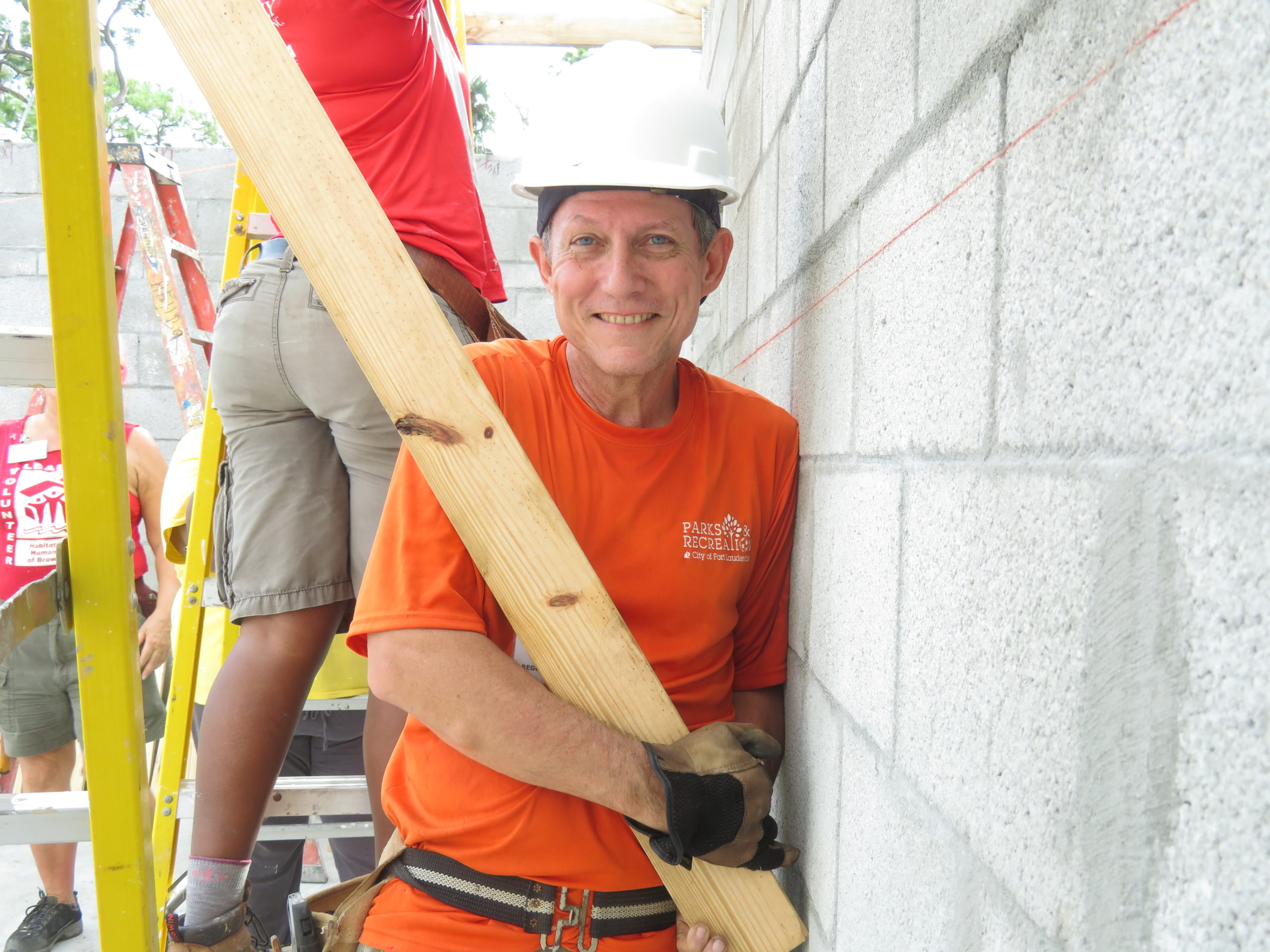 IMG_1210 image_Kelly Kolb wearing orange shirt installing trusses
