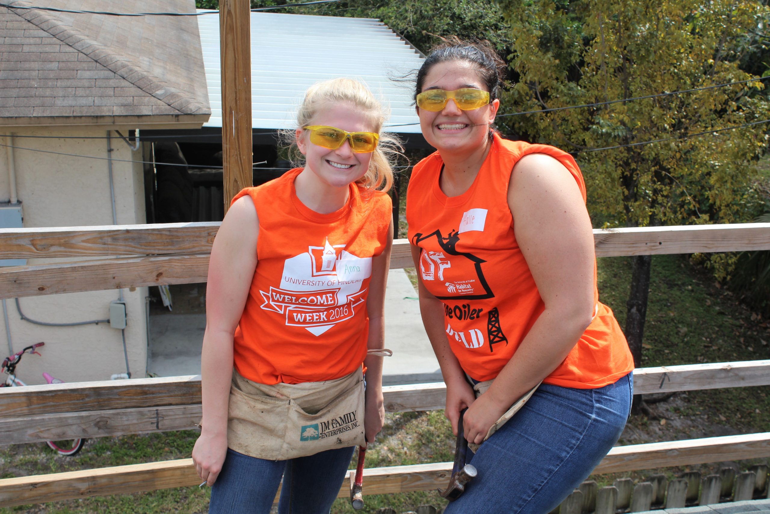 image_2 students wearing orange shirts, working on roof