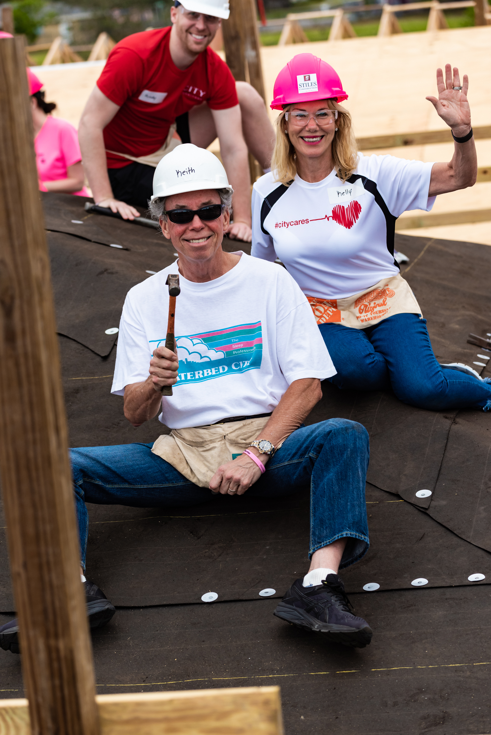 Keith and Kelly wave from roof image_Keith & Kelly Koenig helping on the roof