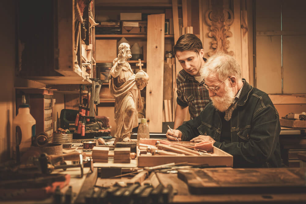 Senior Restorer and His Apprentice Working With Antique Decor Element in His Workshop.